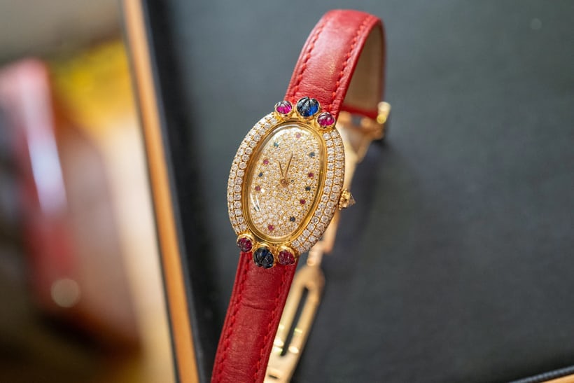 Cartier Baignoire with multi-colored jewels and a red leather strap