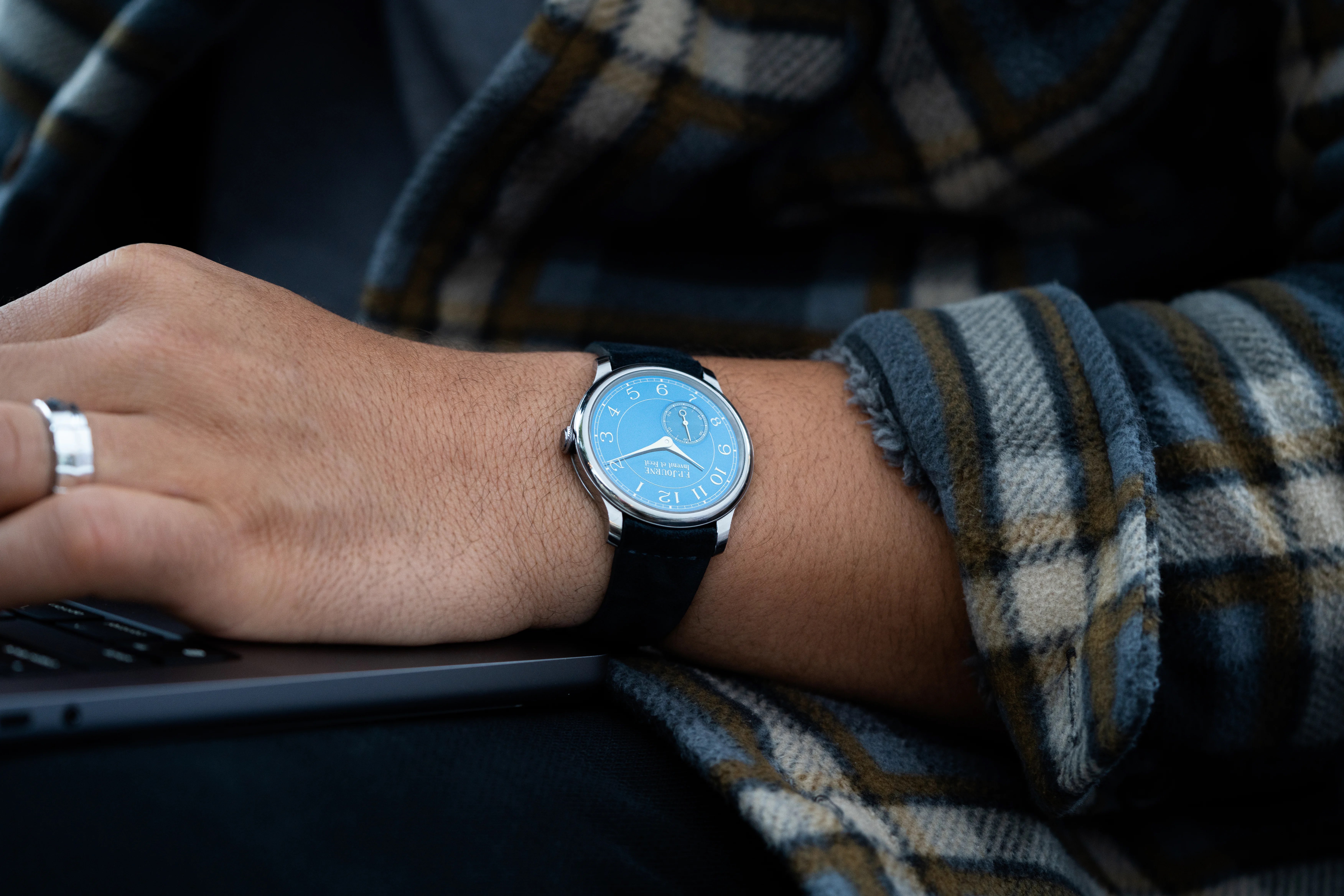 watch on wrist of someone working on computer