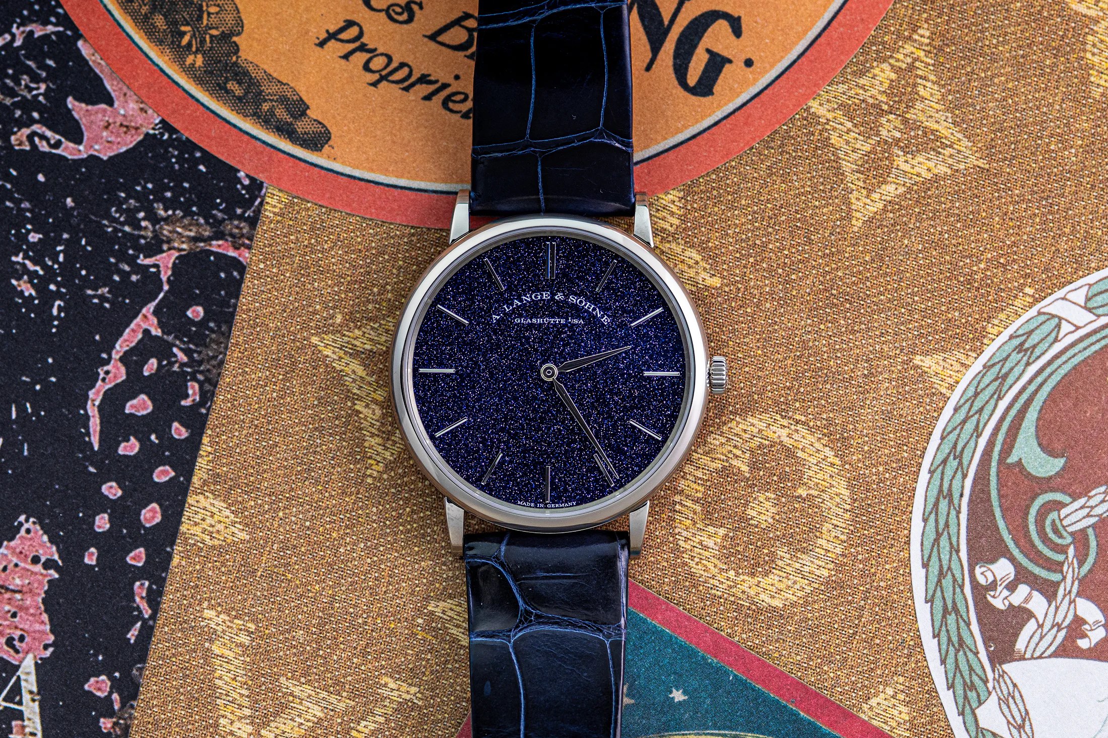 A. Lange & Sohne saxonia thin watch on an ornate background