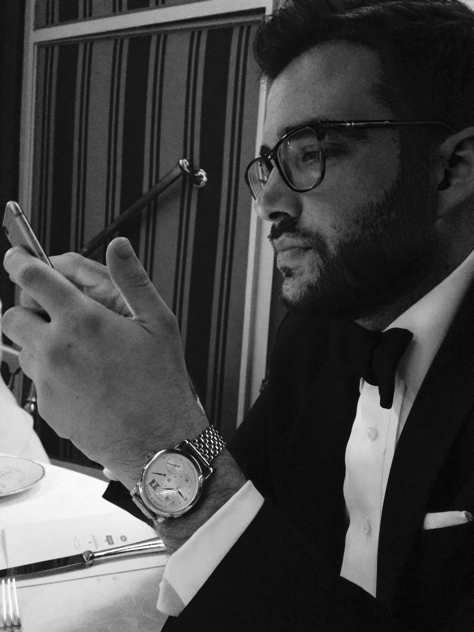 ben clymer in black tie with lange wristwatch