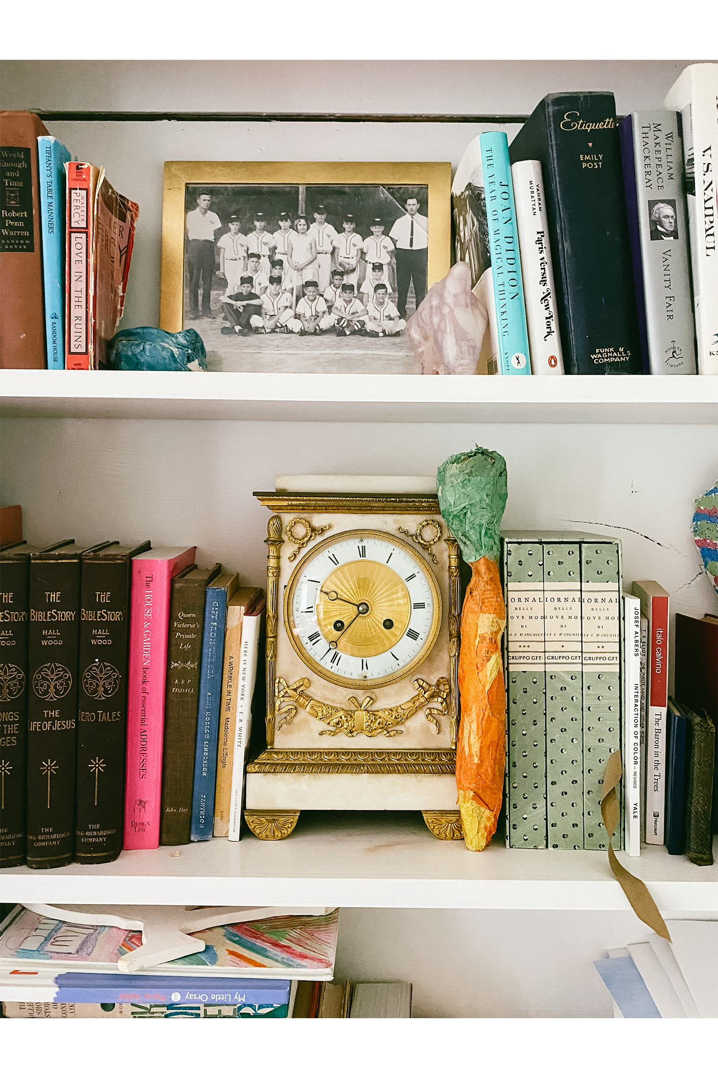 An antique clock on a shelf