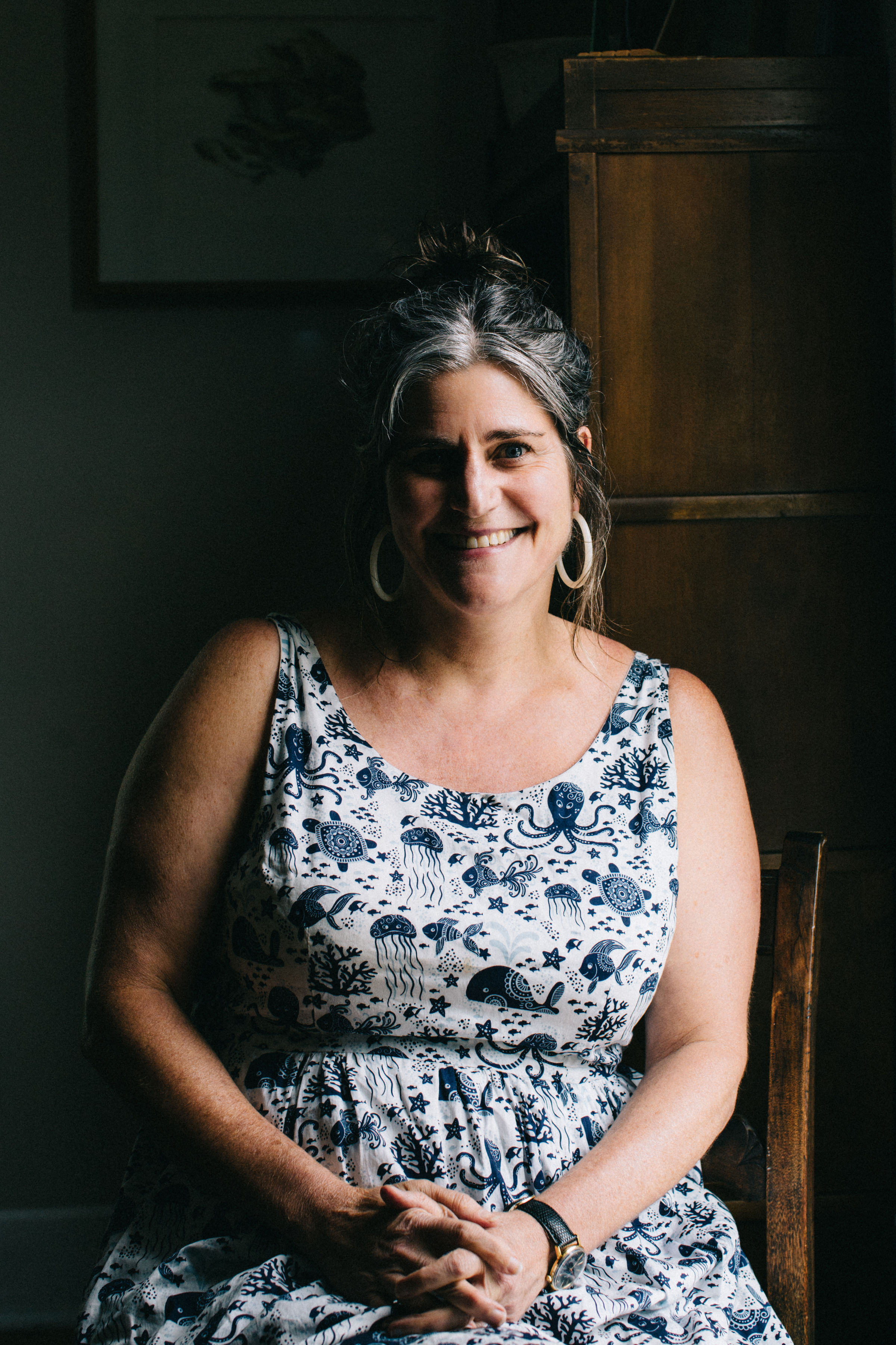 A women wearing a floral dress and watch 