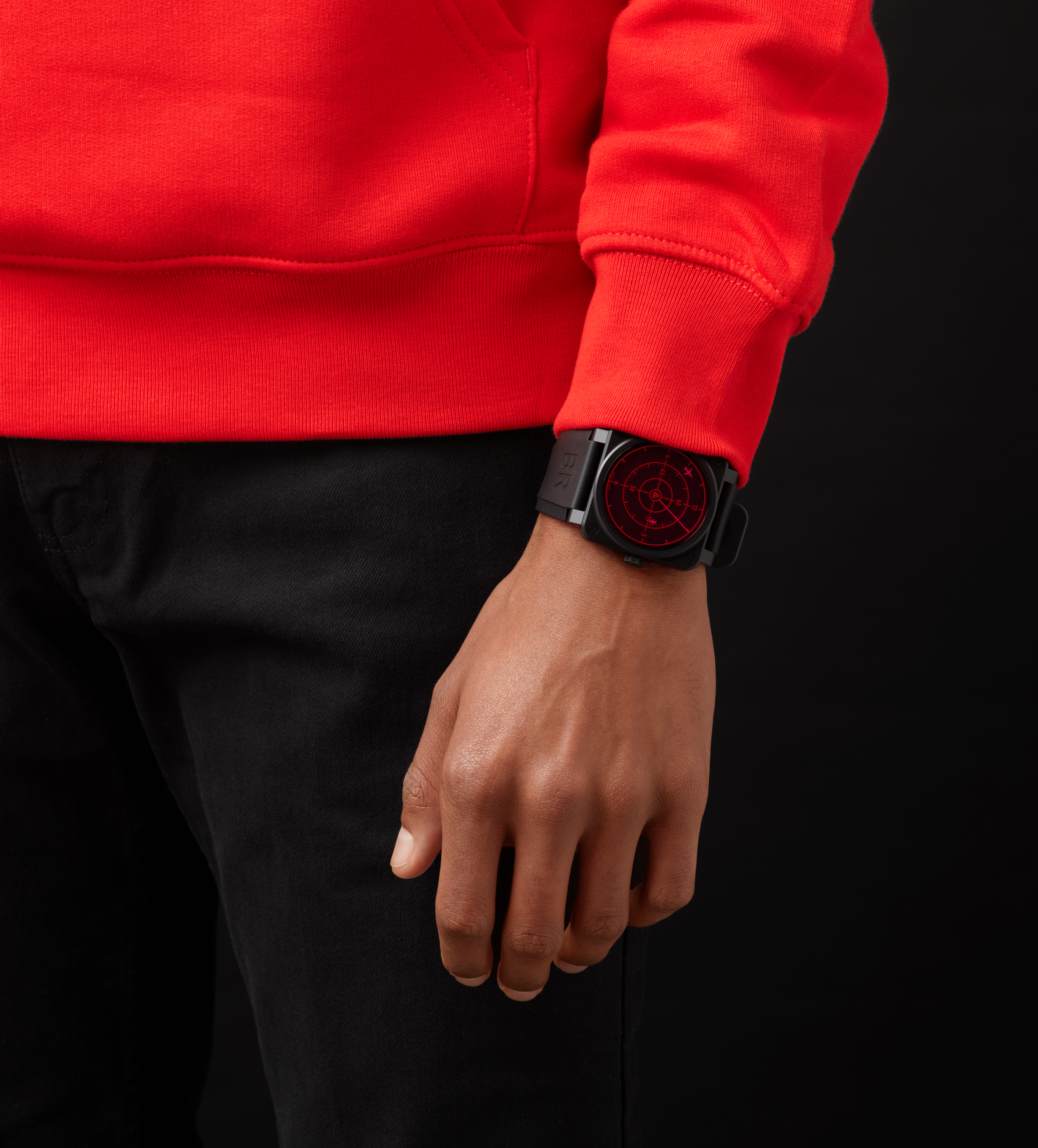 A person in a red sweatshirt wearing a Bell-Ross watch