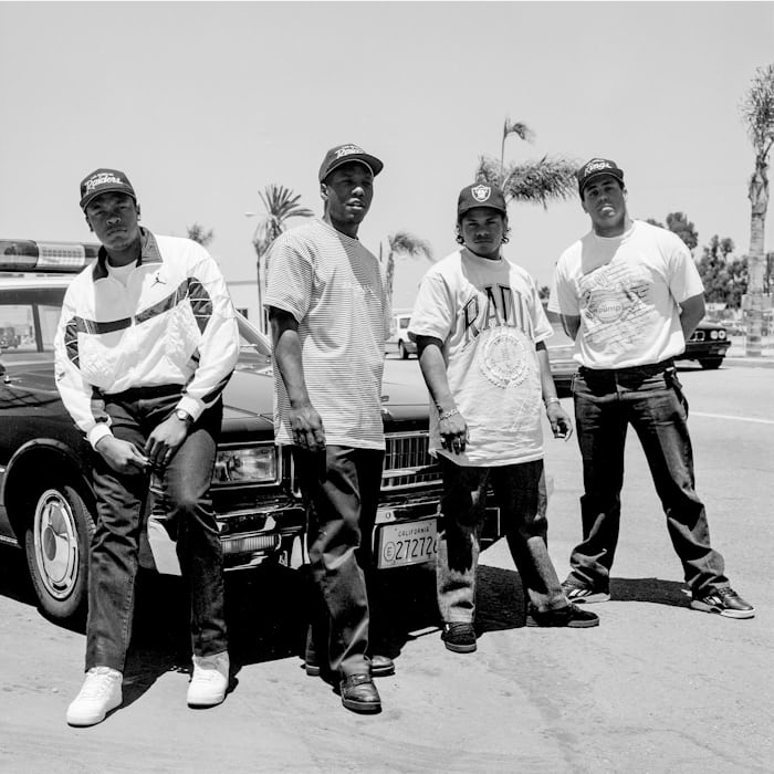 N.W.A. posing in front of a car