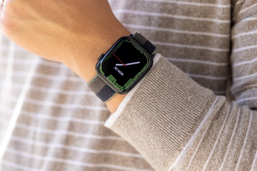 The Apple Watch Series 7, with World Time face, on a male model