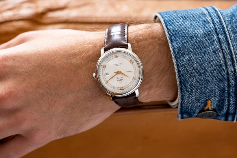 The Omega De Ville Prestige worn on the wrist of a male model.