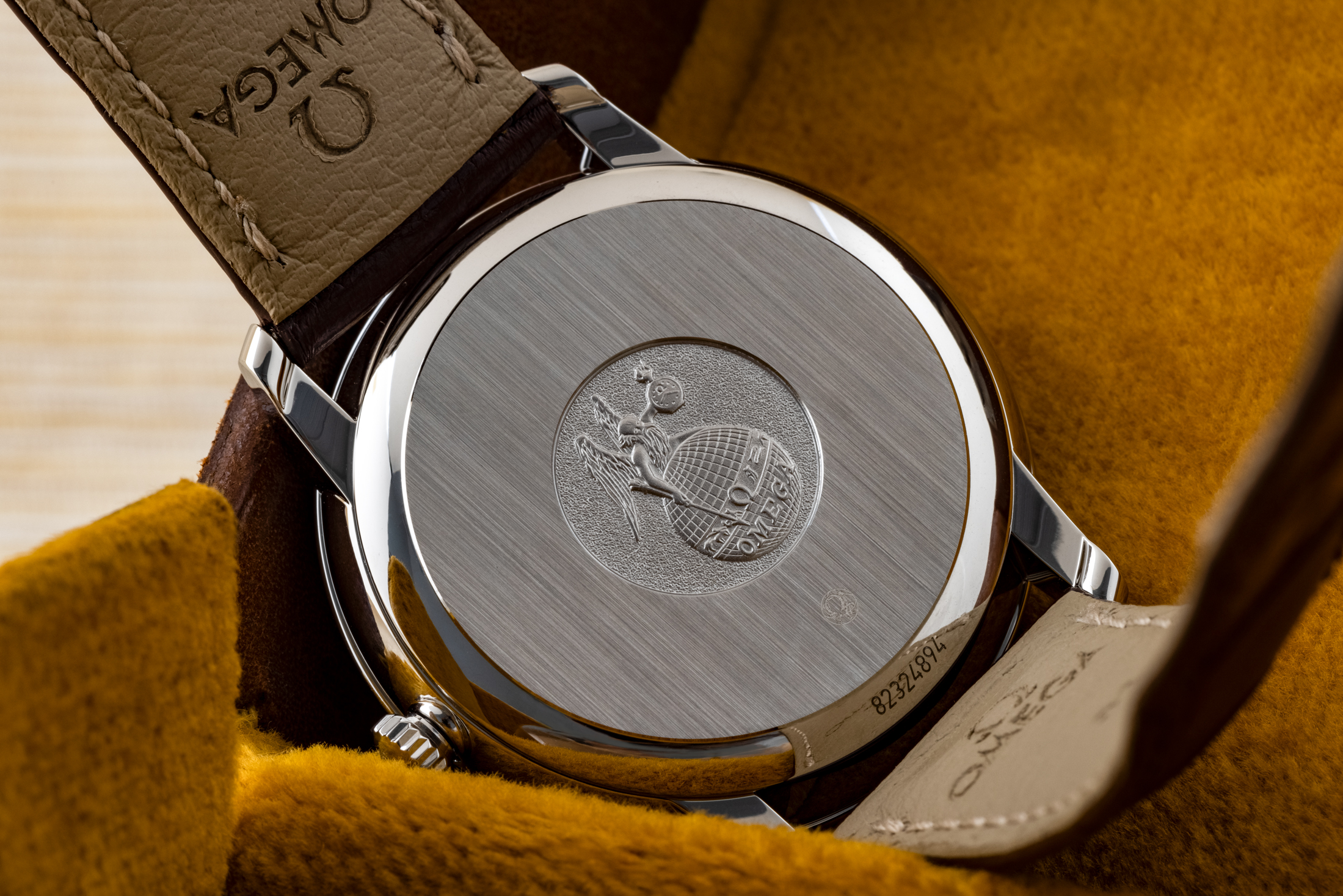 Caseback of the Omega De Ville Prestige, showing an engraving of the original Omega globe logo