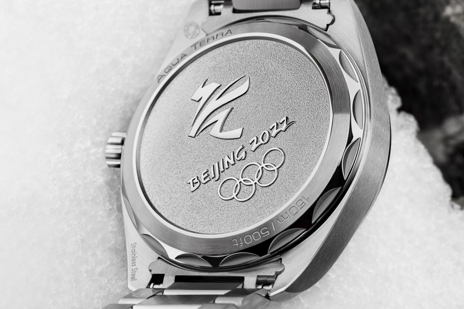 Caseback of the Omega Seamaster Aqua Terra Beijing 2022 in the snow with the Olympic logo engraved