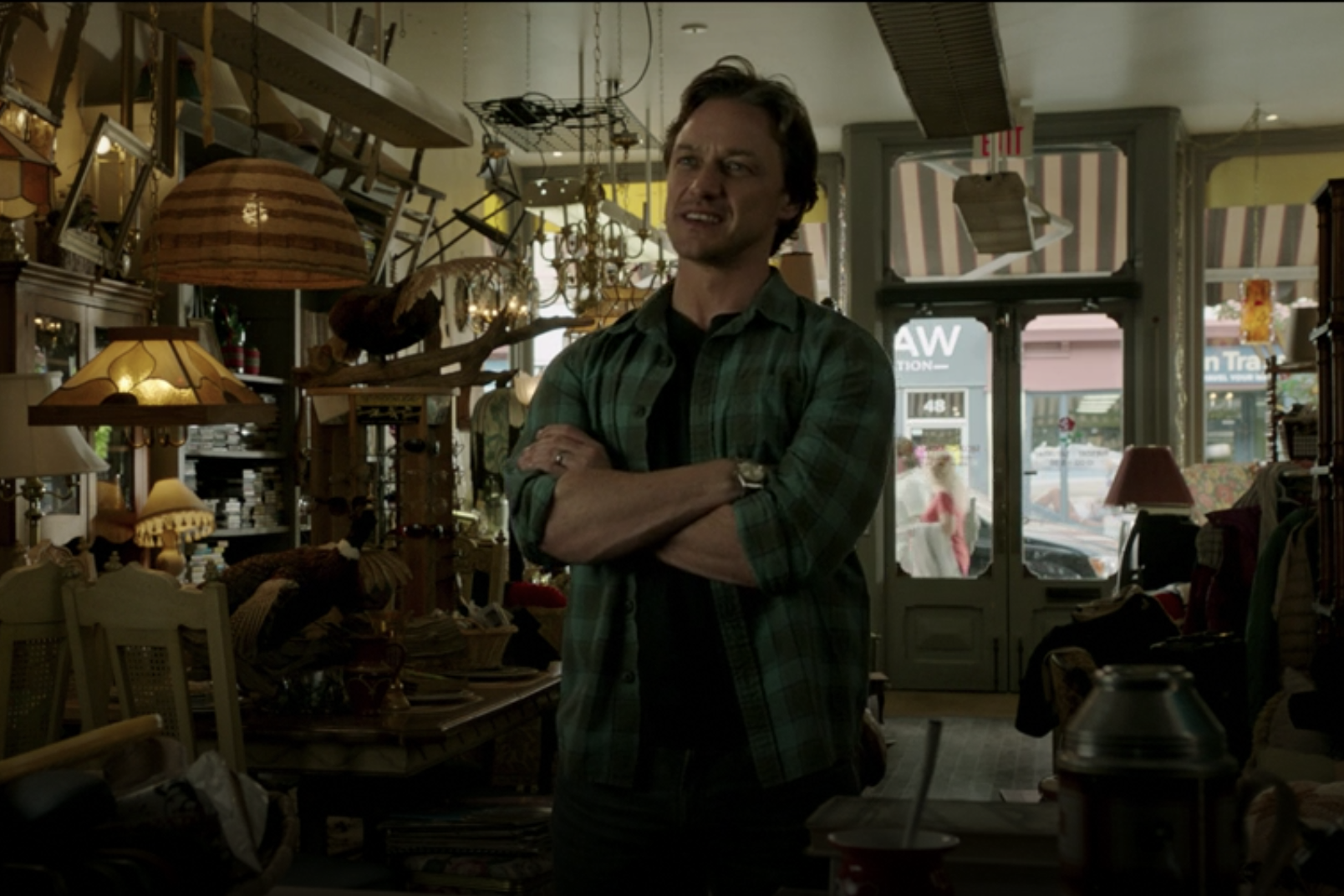 Bill Denbrough in his blue button shirt wearing his Rolex Datejust in a vintage shop.