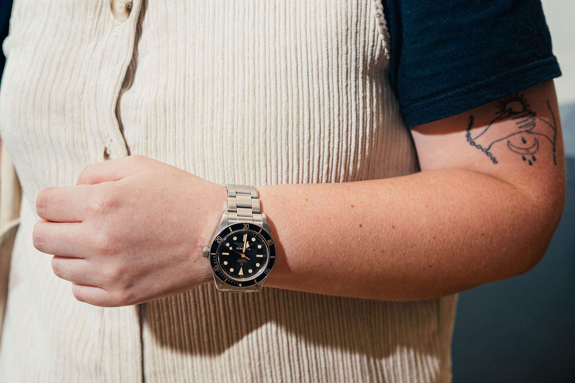 A wrist with a black dial watch 