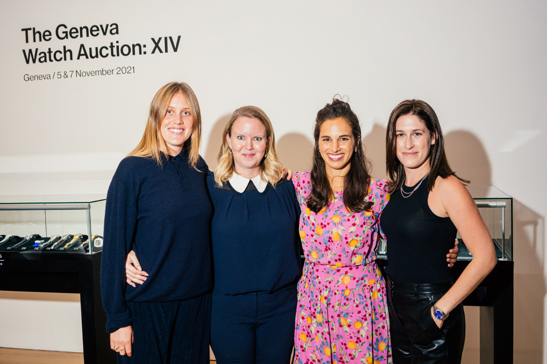 Four people standing closely together