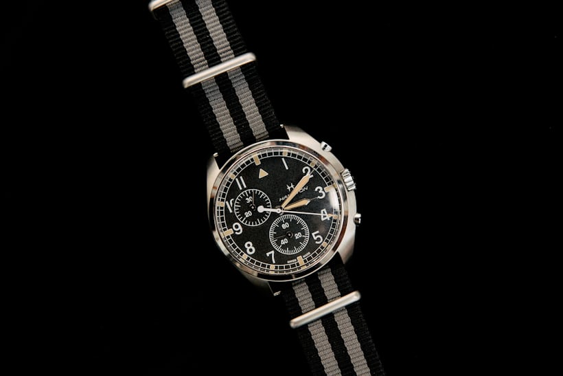 A black Hamilton watch on a black background