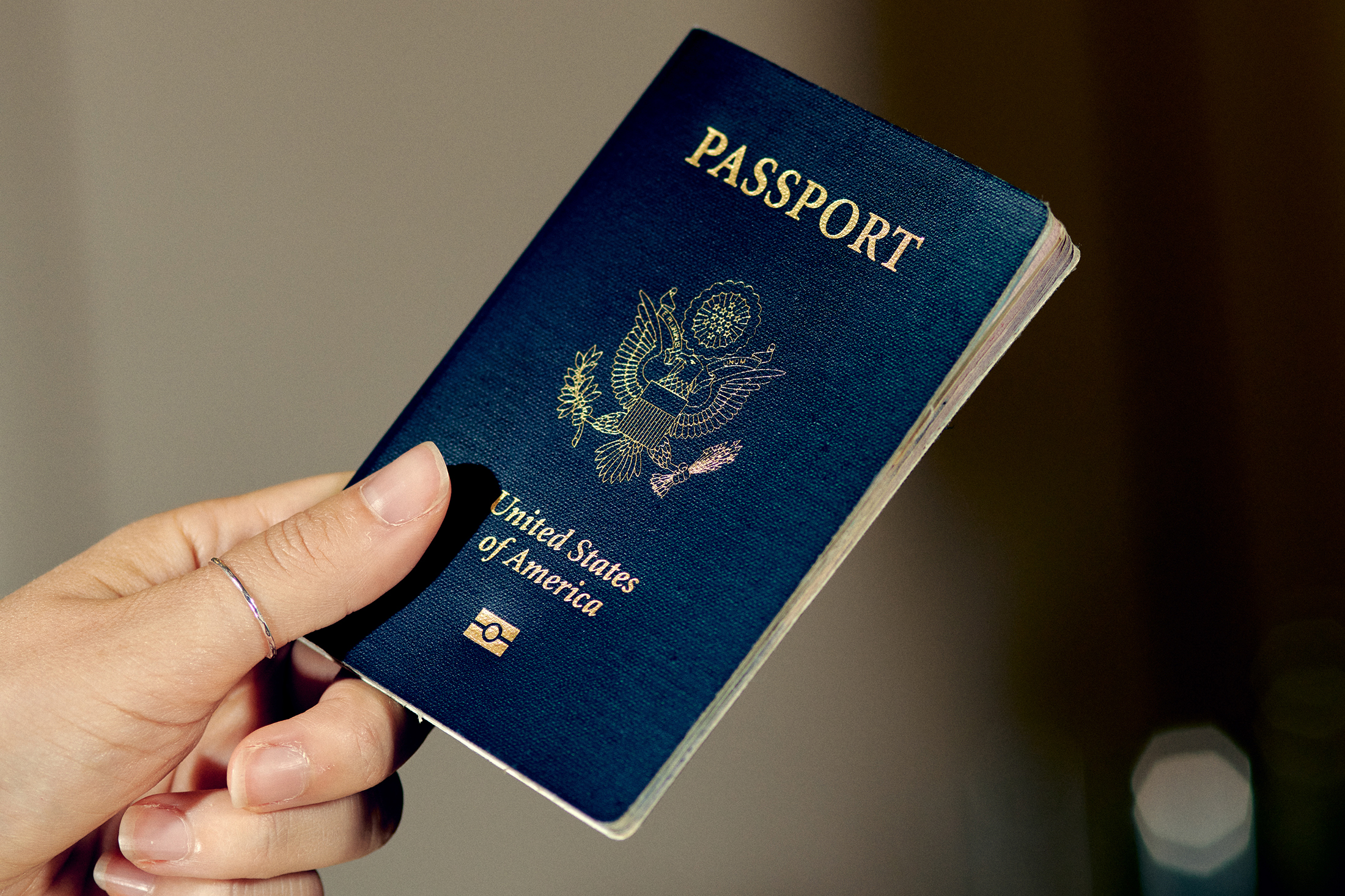 An American passport in a hand