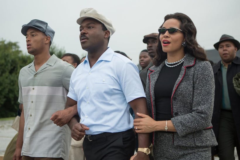 David Oyelowo as Martin Luther King Jr. wearing his solid gold Rolex Datejust, a blue shirt, and a hat, alongside Carmen Ejogo, playing Coretta Scott King wearing sunglasses in Selma