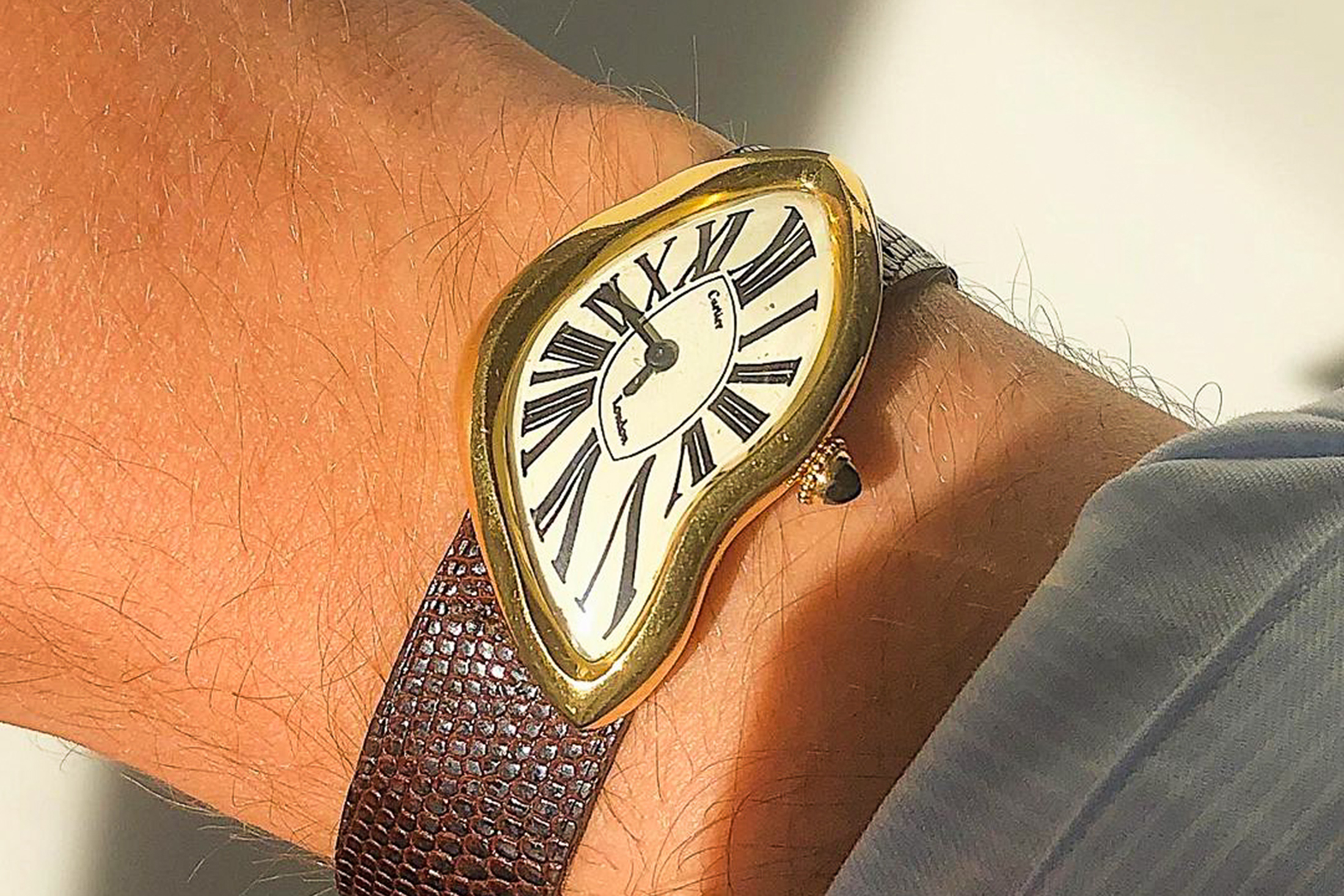 A Cartier Crash watch on a wrist