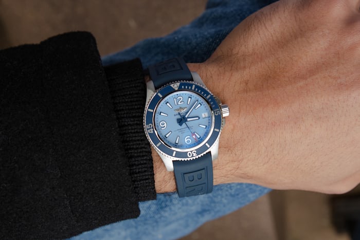 A blue Breitling watch on a wrist 