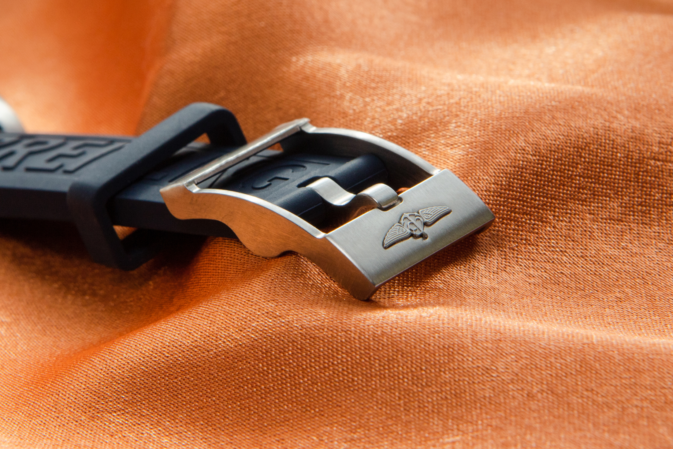 A watch strap on an orange background