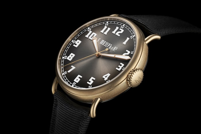 An H. Moser watch on a black background