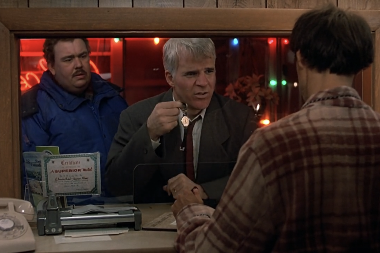 Steve Martin holding his Piaget Polo in a motel