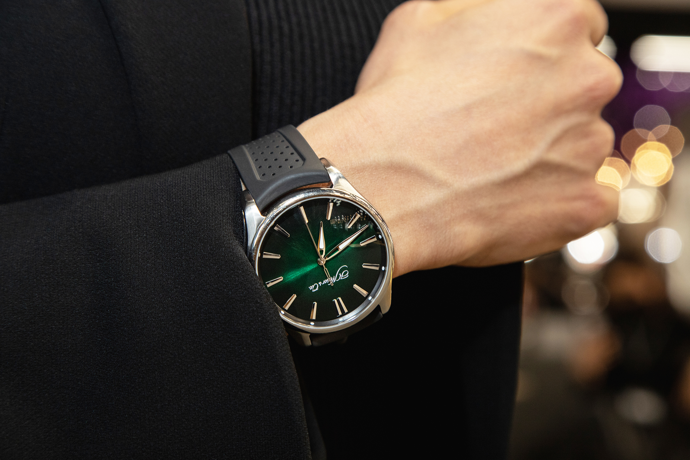 A person wearing an H. Moser watch