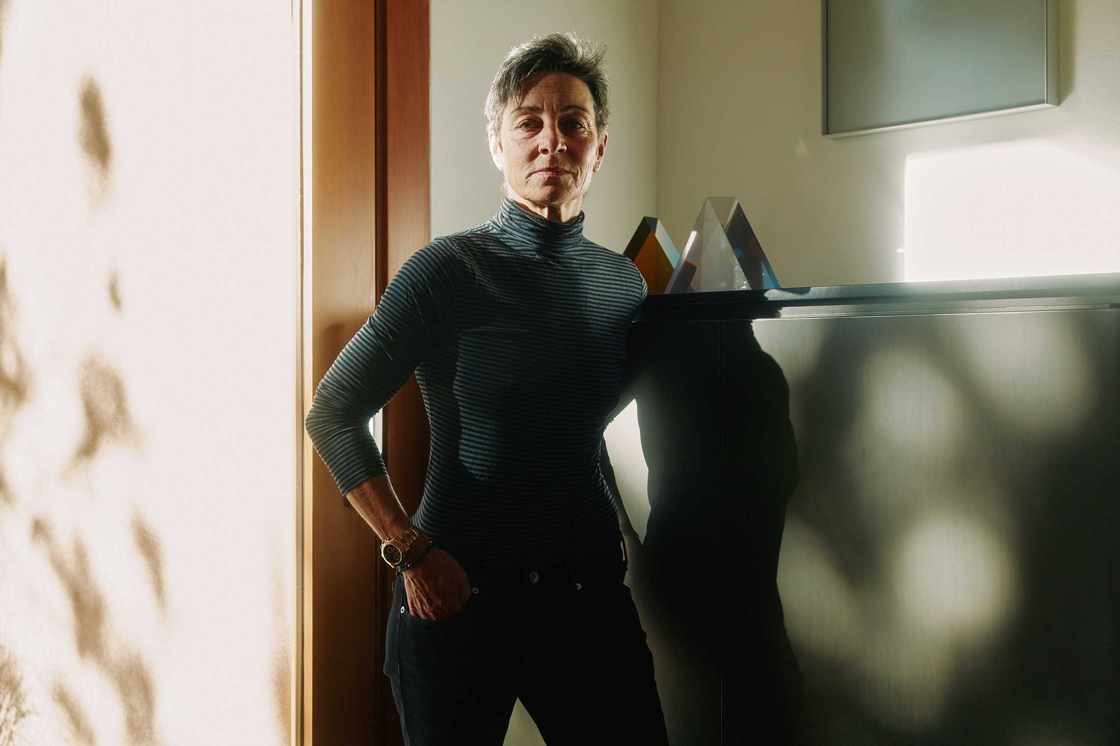 A person stands with a Rolex on their wrist