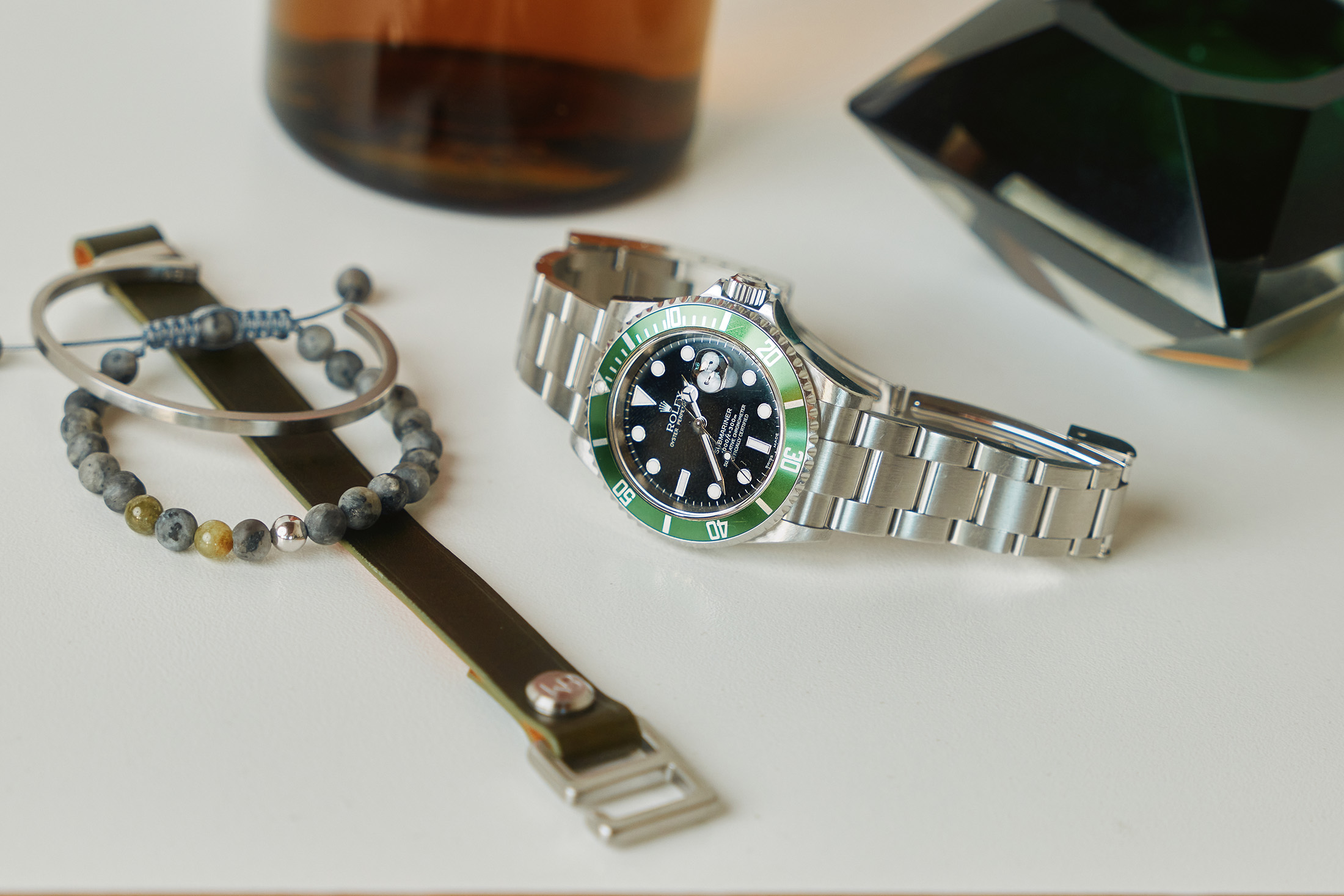 A Rolex Submariner with a green bezel 