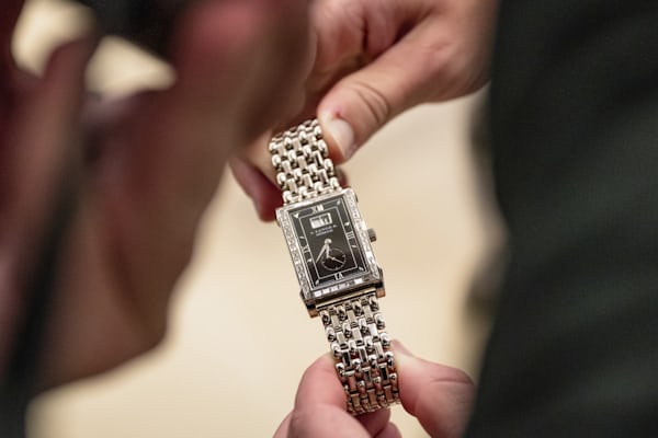 A rectangular A. Lange & Söhne with diamonds is held up by a man
