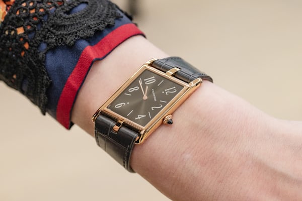 A Cartier watch on a woman's wrist.