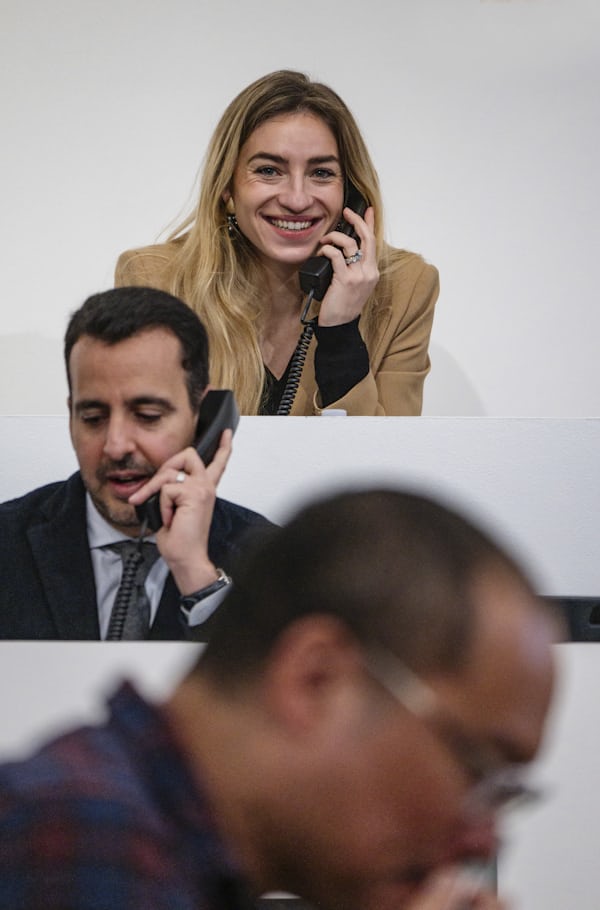 A woman smiles on the phone.