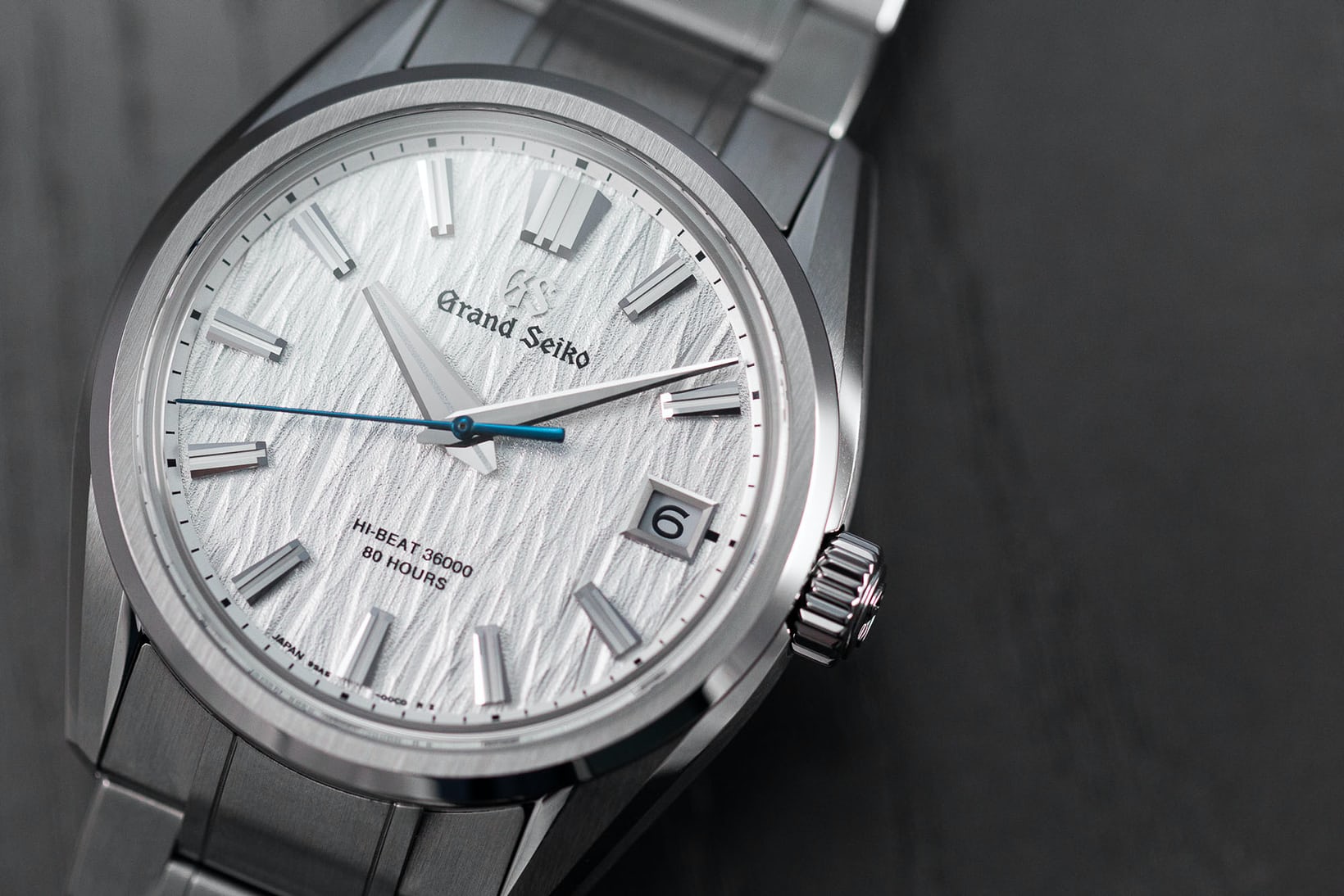 A Grand Seiko "White Birch" watch on a black background