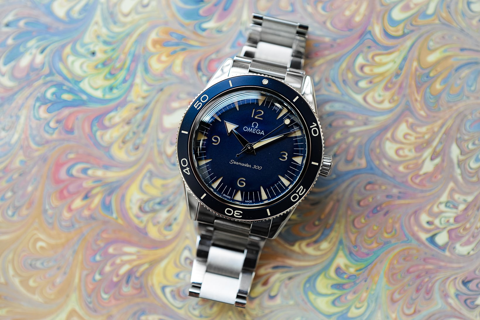 Omega Seamaster 300 on a multicolored background 