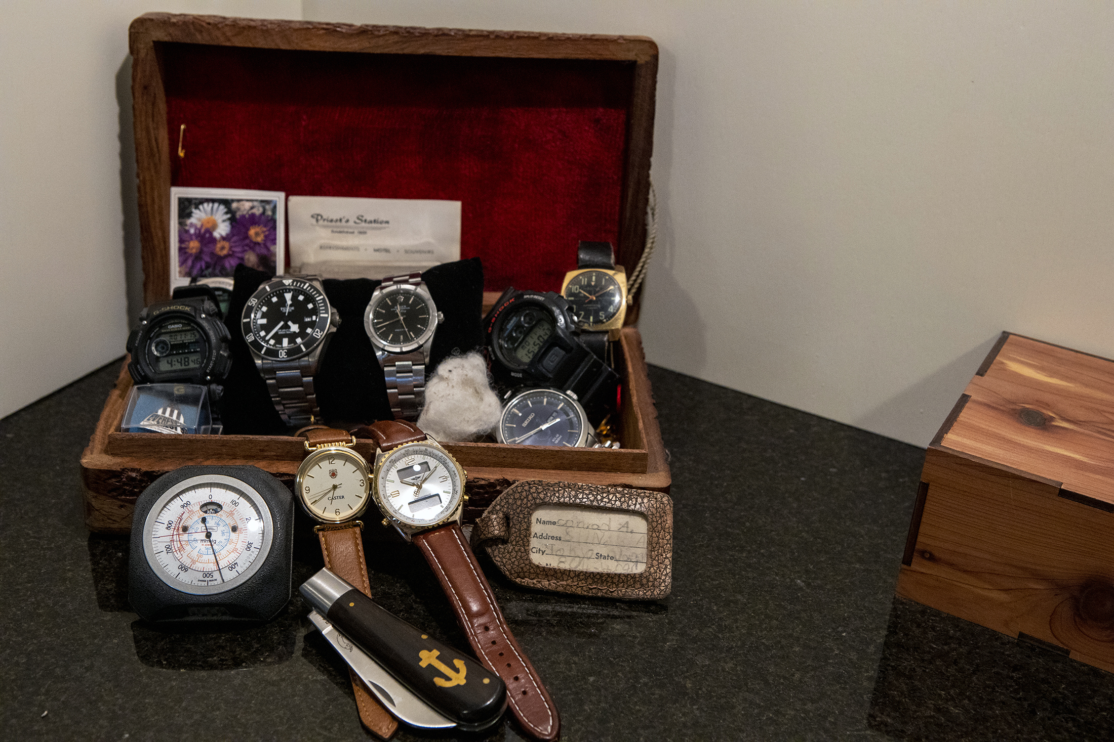 A collection of watches in a red-lined boxed