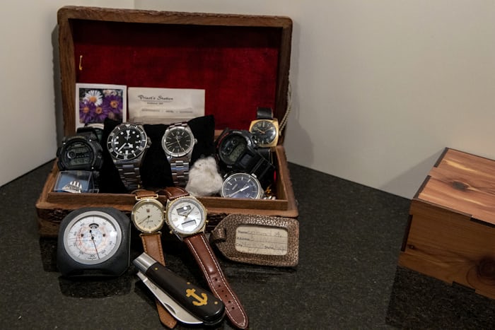 A collection of watches in a red-lined boxed