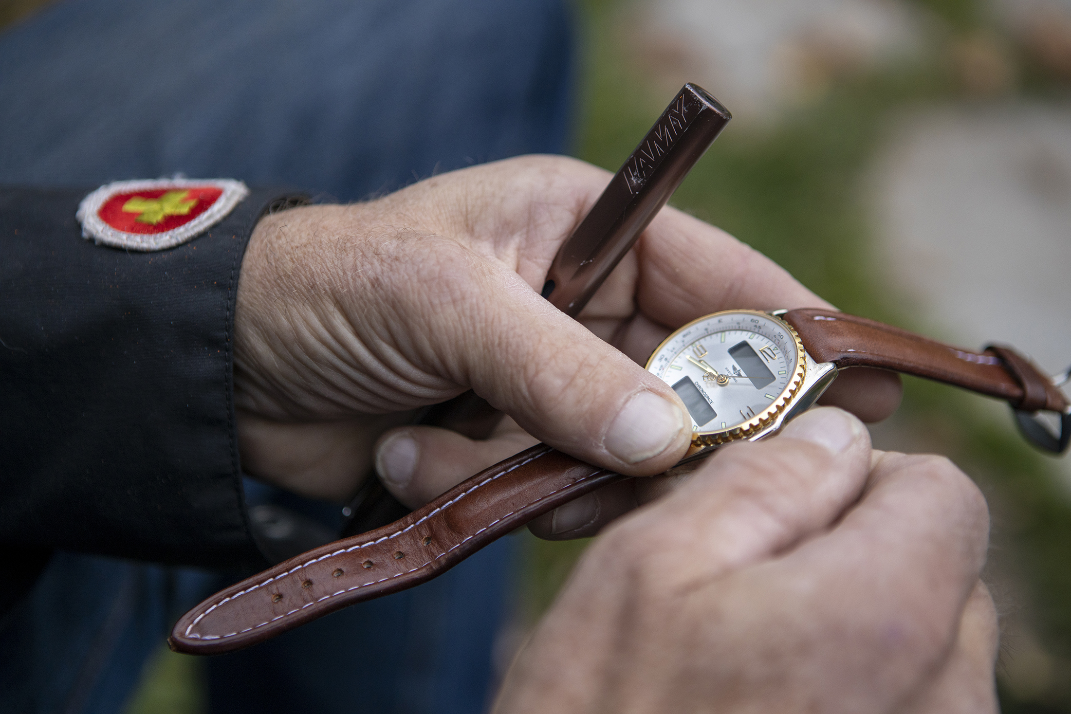 A man holds a watch in his two hands