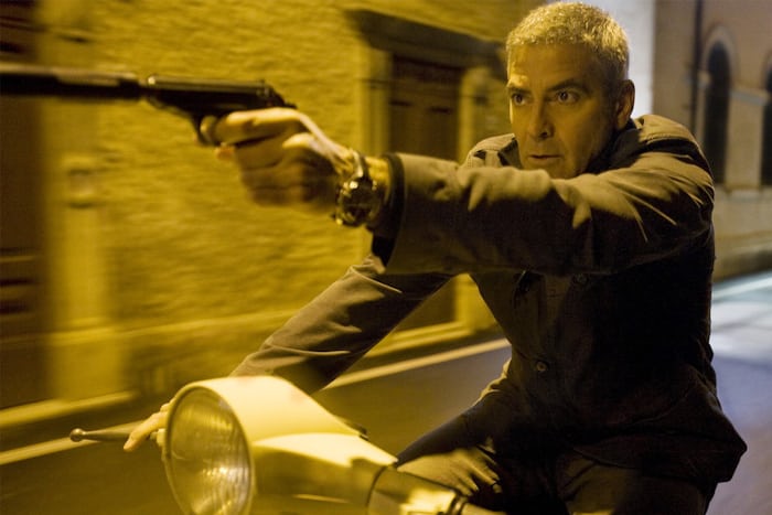 George Clooney firing a gun on a Vespa, while wearing a Speedmaster in 'The American