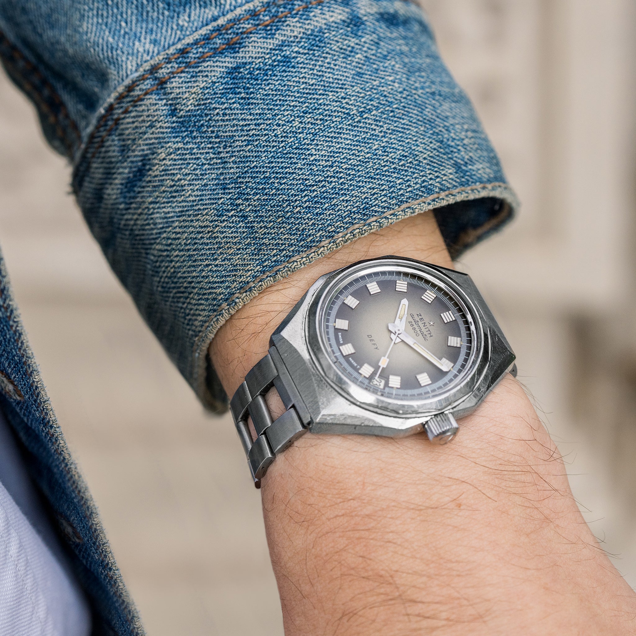 a vintage Zenith Defy wristwatch on a man's wrist.