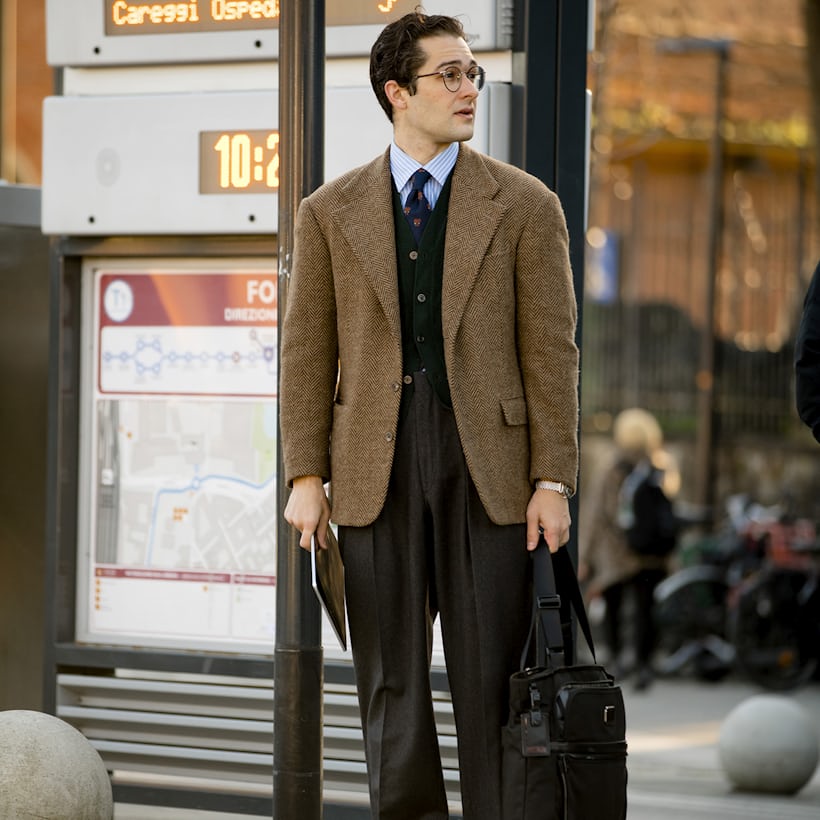 A man in a blazer on a corner