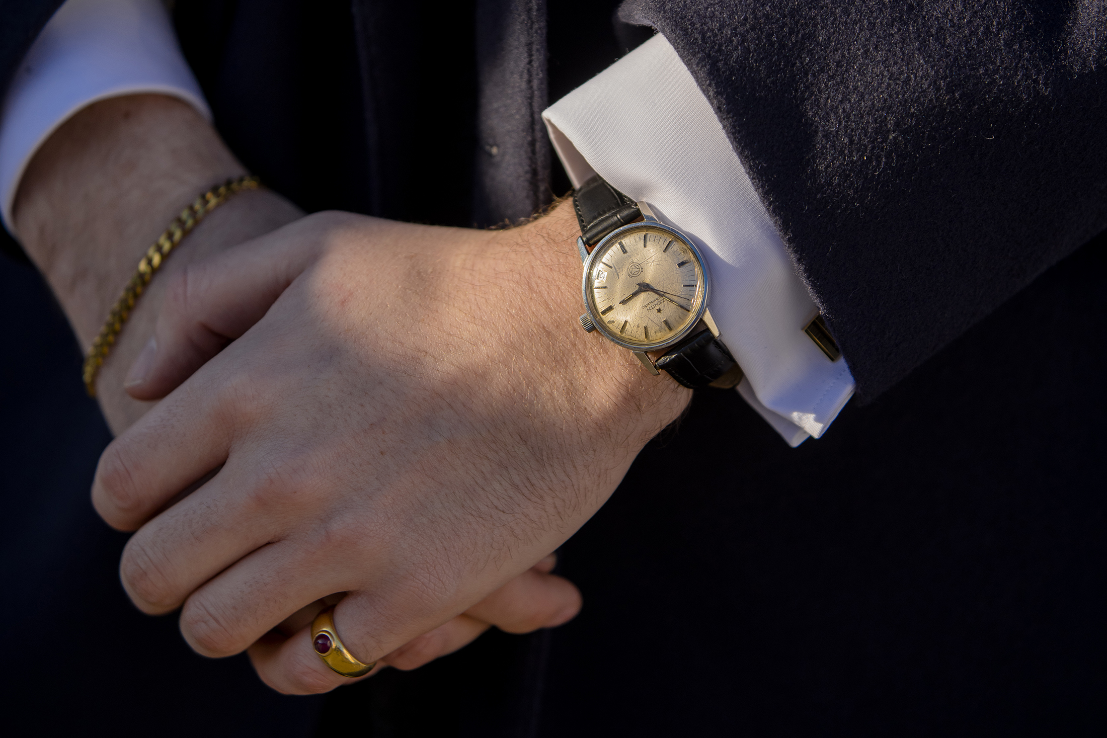 A person with their hands crossed wearing a watch