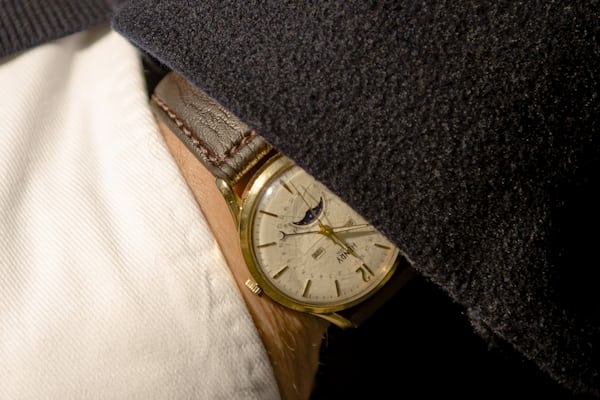A white dial watch with a moonphase