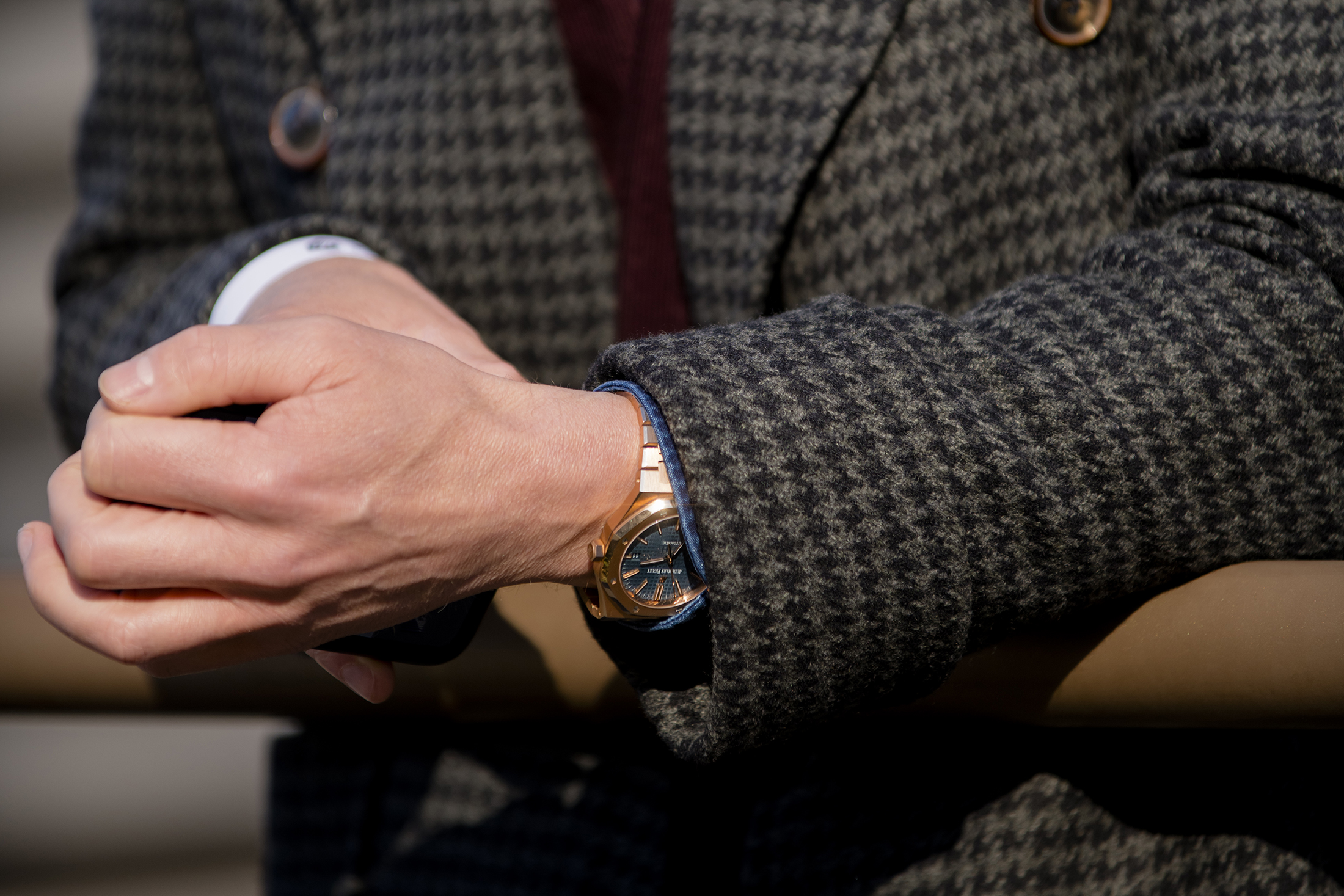 A watch sticking out from underneath a suit jacket