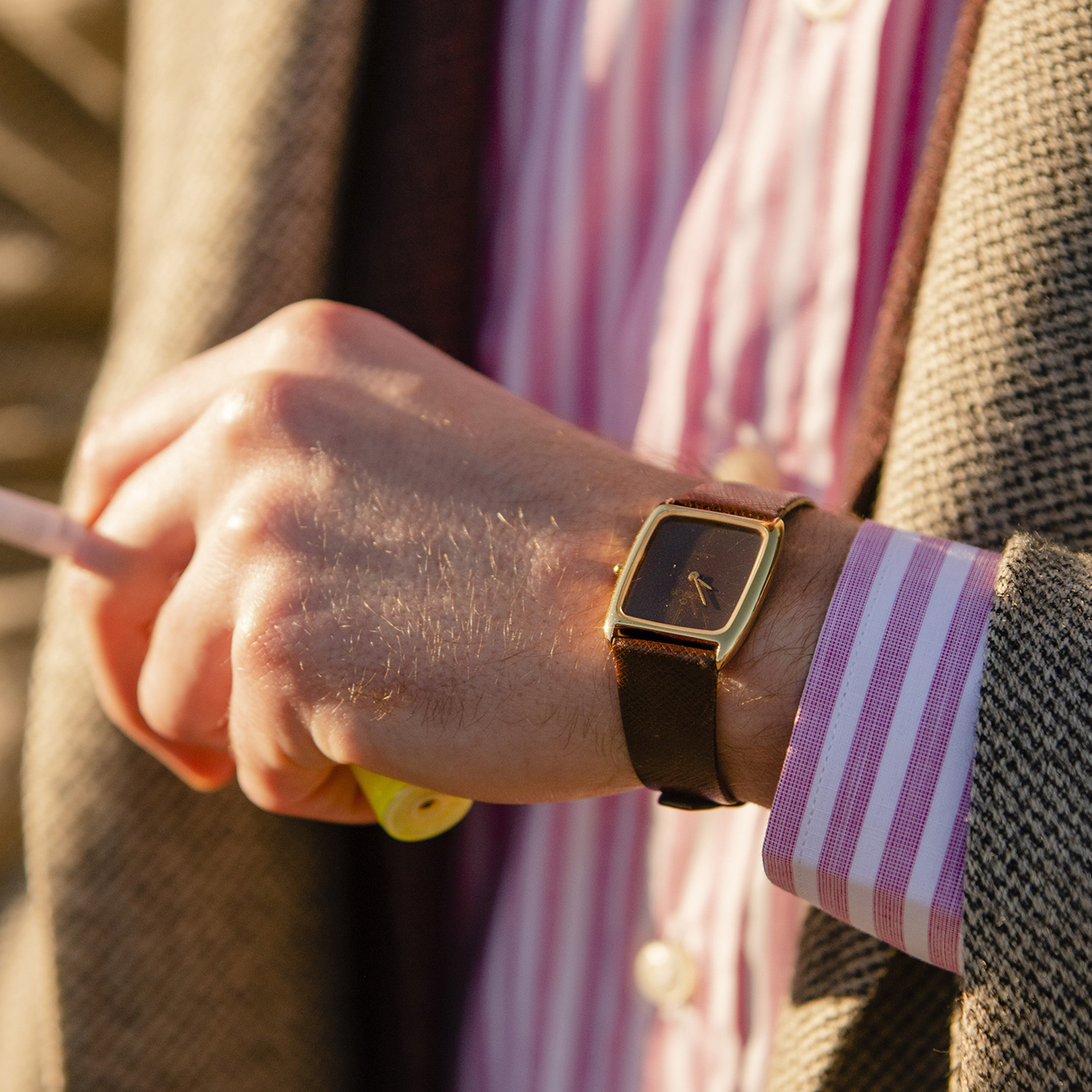 A red dial watch on a wrist