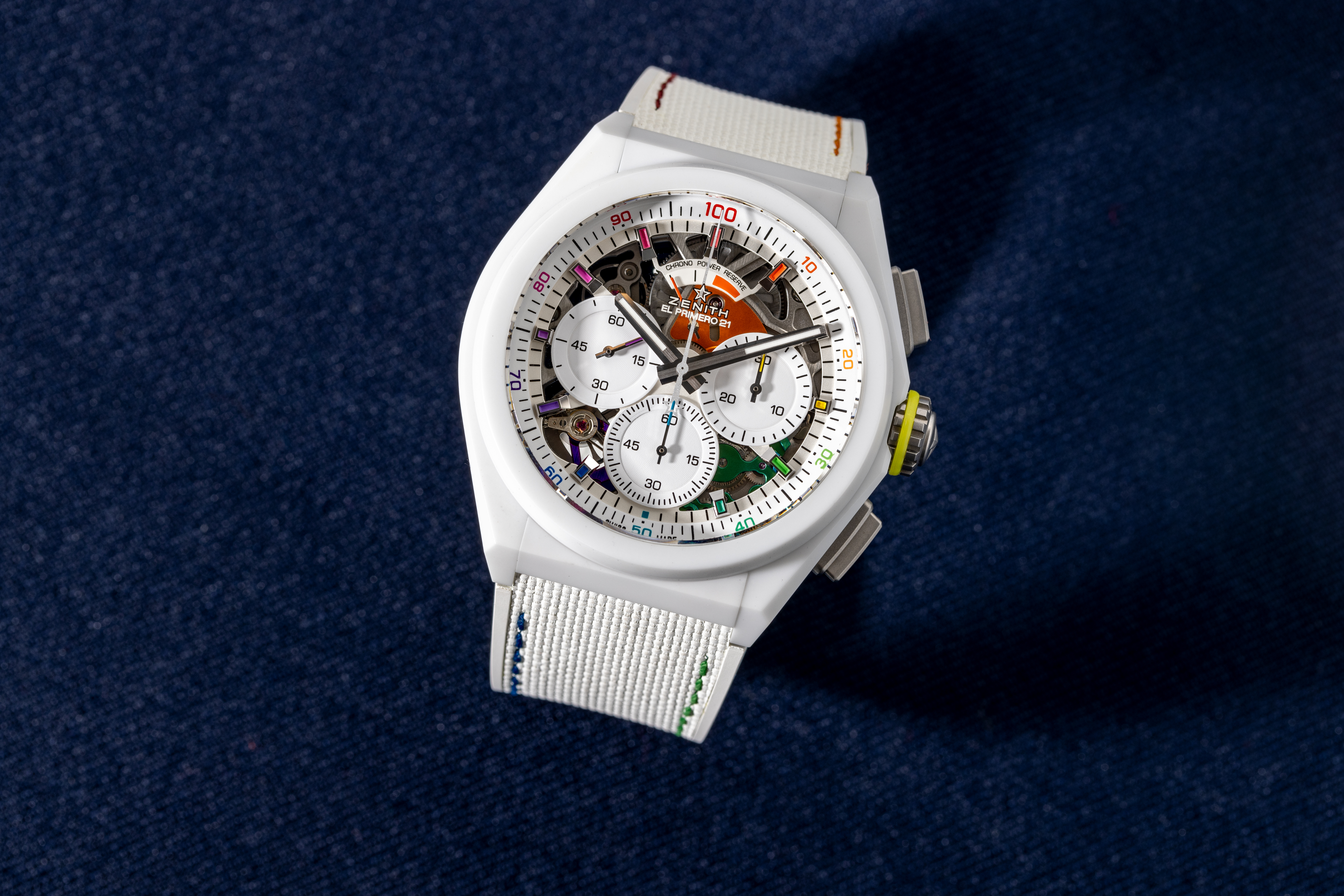 The Zenith Defy 21 Chroma sits upright on a blue background