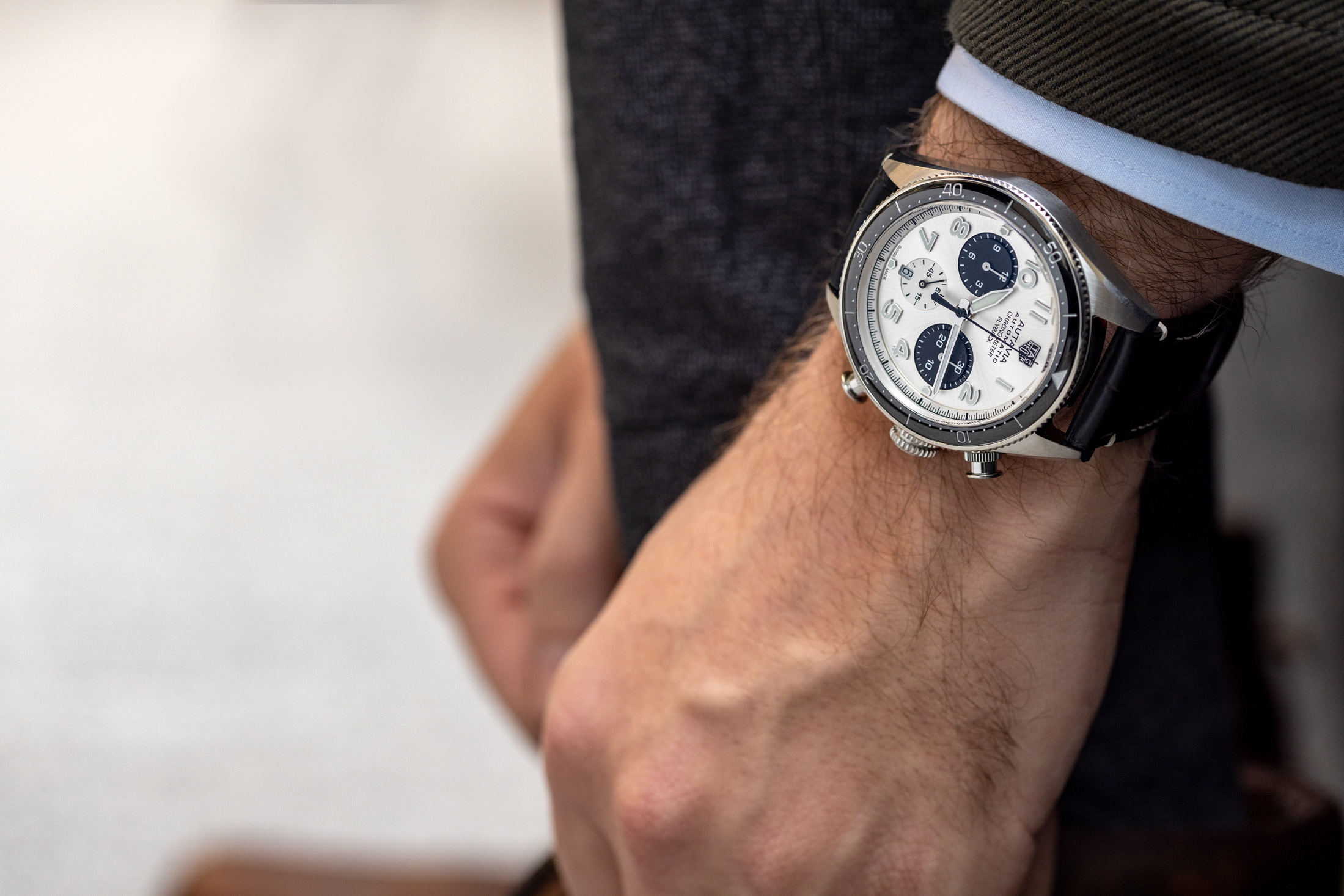 TAG Heuer Autavia on wrist tying shoes