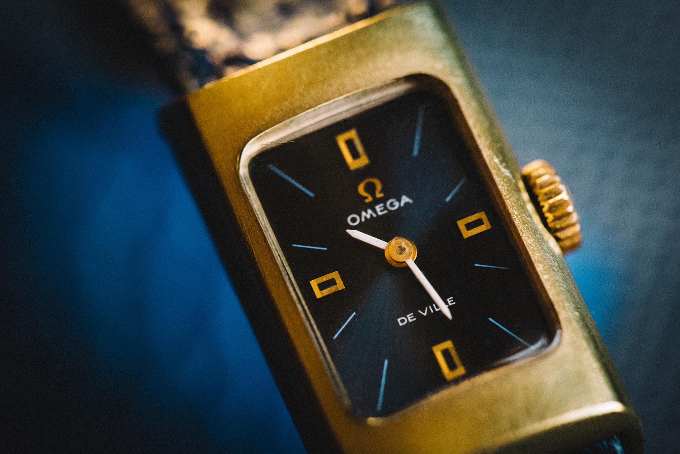 A close up of the dial of an Omega De Ville 