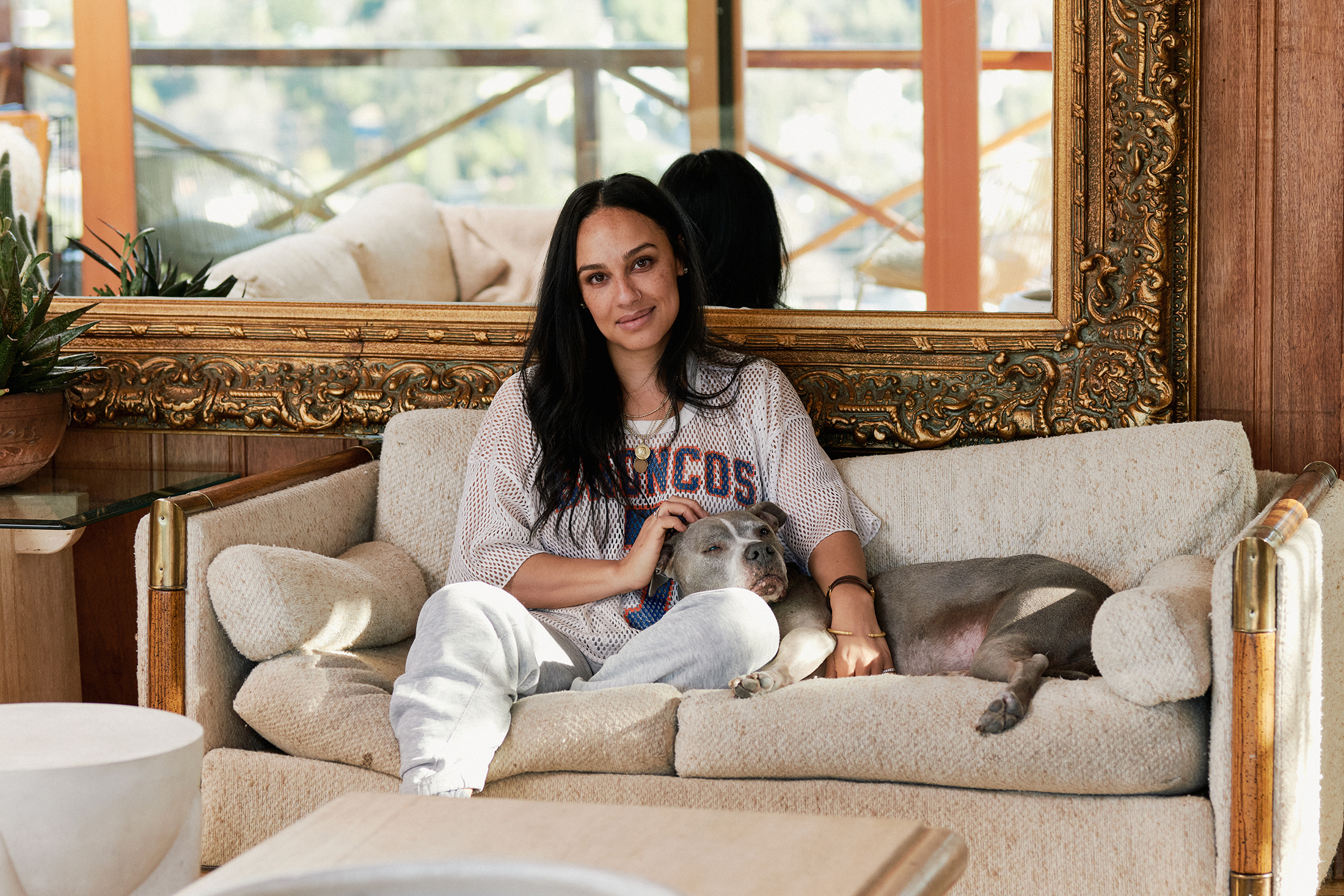 Maggi Simpkins on a couch with a dog