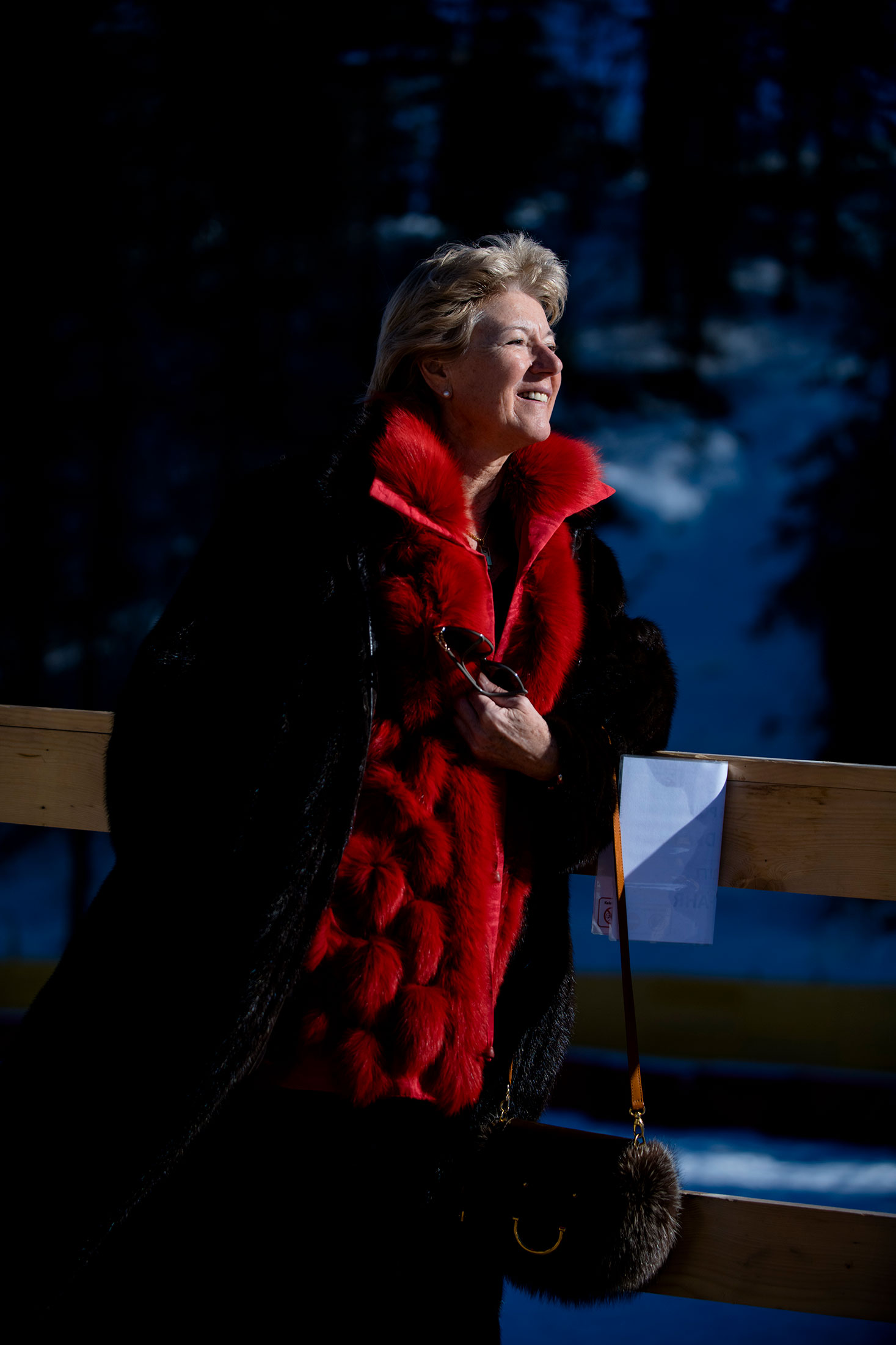 A woman in a black fur coat