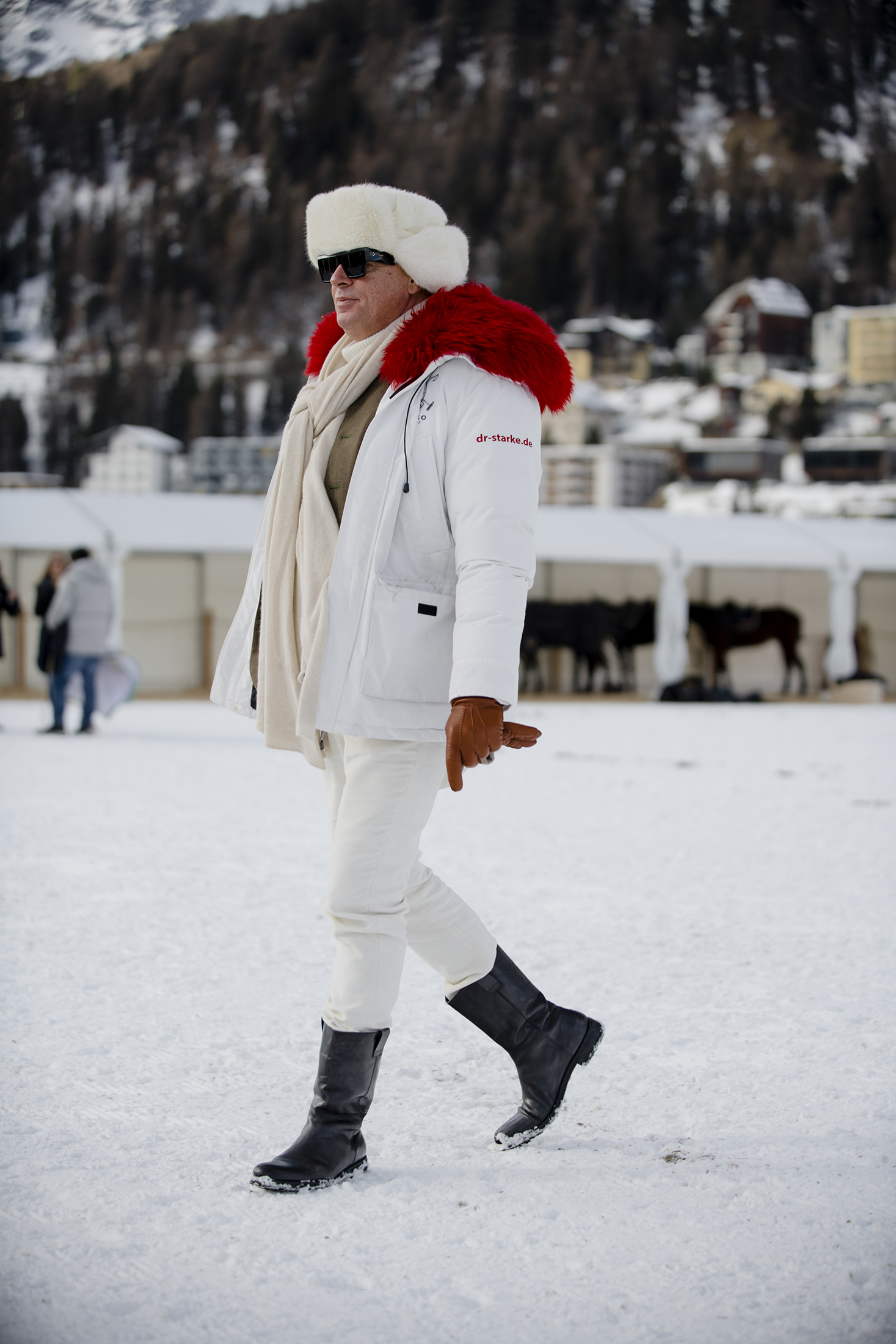 A person in head to toe white clothing in the snow 