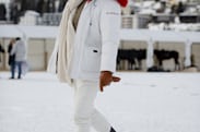 A person in head to toe white clothing in the snow 
