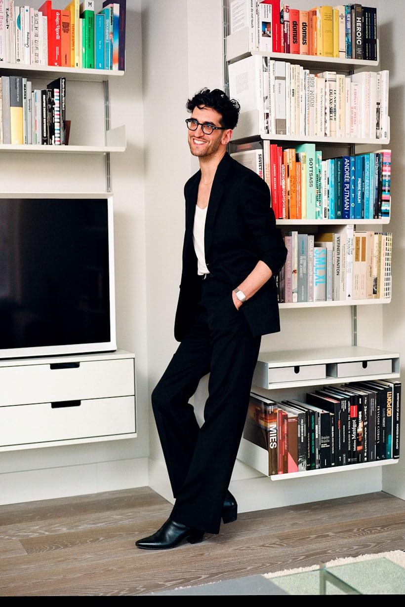 David Macklovitch leans against a bookshelf