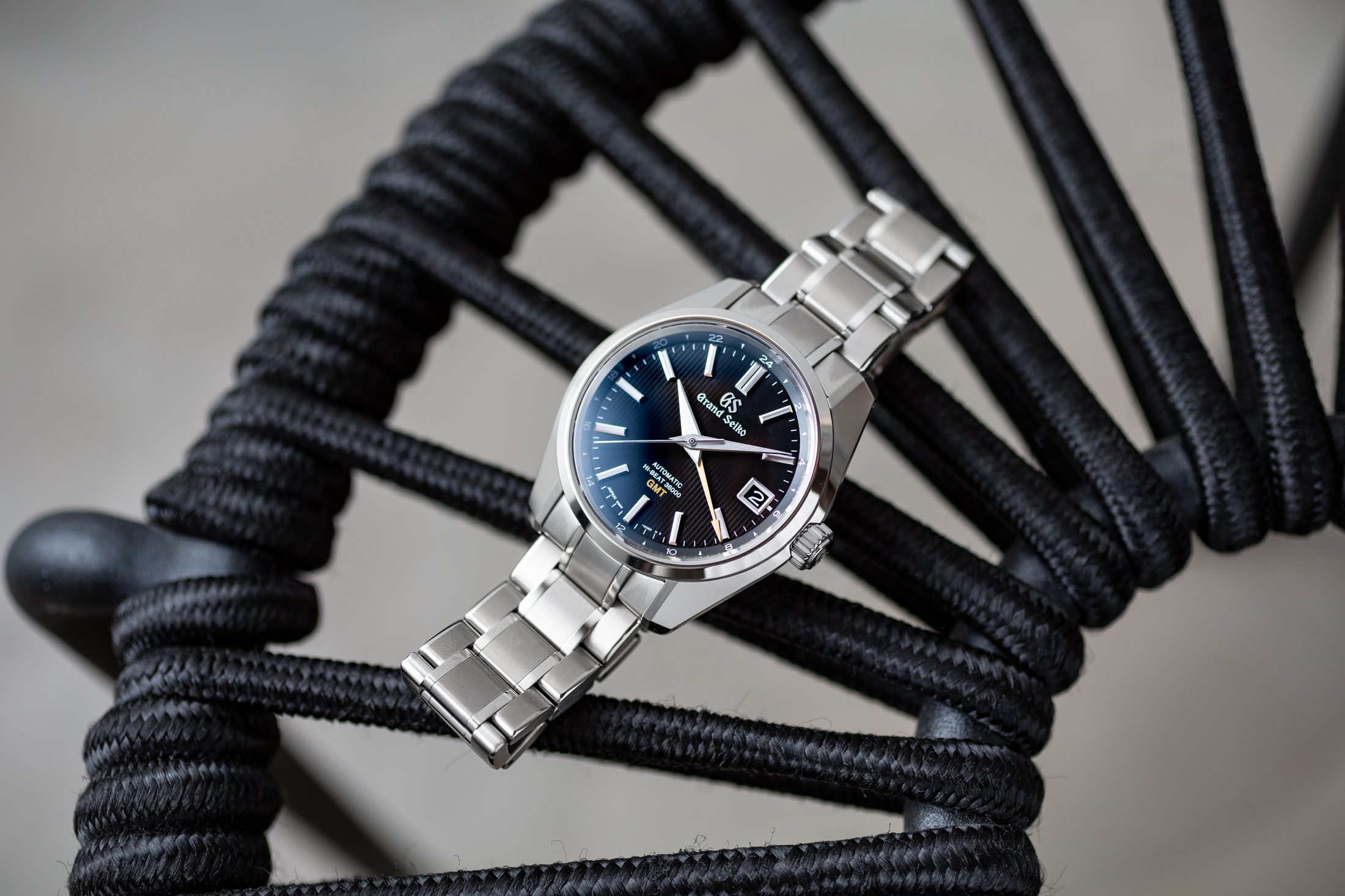 A Grand Seiko Hi-Beat GMT on a chair. 